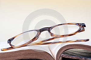 Reading glasses on opened book