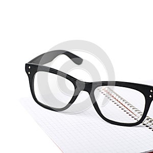 Reading glasses over a notebook