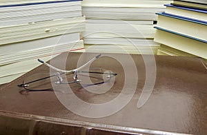 Reading glasses on pile of books