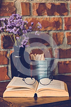 Reading glasses on table with open book