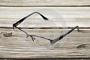 Reading glasses and wood background