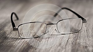 Reading glasses on wooden table