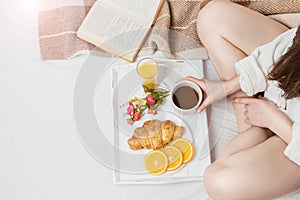 Reading and having breakfast in bed.