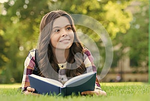 Reading helps your seed of knowledge grow. Happy kid read book lying on green grass. Knowledge day. September 1. Back to