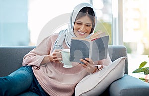 Reading is her favourite pasttime. an attractive young woman enjoying a cup of coffee and reading her book while