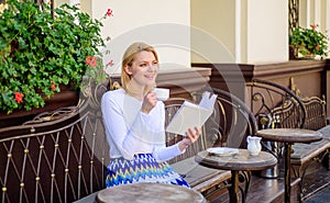 Reading is her hobby. Mug coffee and interesting book best combination perfect weekend. Girl drink coffee while read