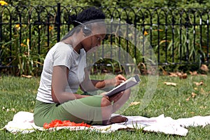 Reading and listening to music in the park