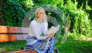 Reading literature as hobby. Woman blonde take break relaxing in park reading book. Ultimate best book list. Girl keen