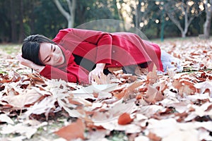 Reading in nature is my hobby, beautiful girl Read book Lying on the fallen leaves in autumn park