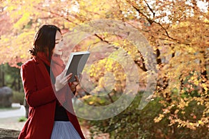 Reading in nature is my hobby, beautiful girl Read book sit on stone in park