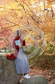 Reading in nature is my hobby, beautiful girl Read book sit on stone in park