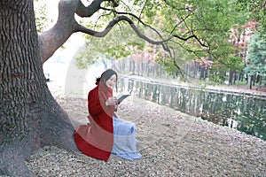 Reading in nature is my hobby, girl Read book sit under big tree