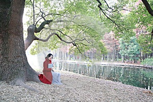 Reading in nature is my hobby, girl Read book sit under big tree