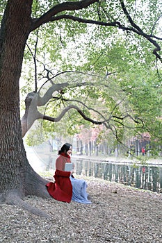 Reading in nature is my hobby, girl Read book sit under big tree