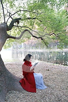 Reading in nature is my hobby, girl Read book sit under big tree