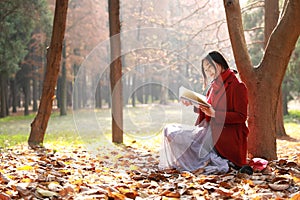 Reading in nature is my hobby, girl Read book sit under big tree