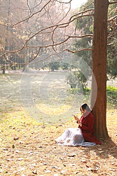 Reading in nature is my hobby, girl Read book under big tree