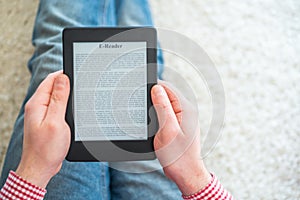 Reading a novel on ebook reader at home