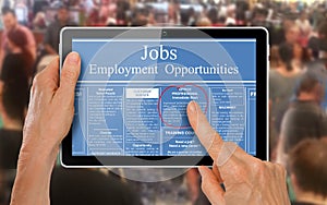 Reading online job ads on a computer tablet -