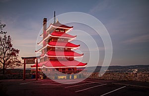 Reading Pagoda glows red with lights on in the pre-dawn light