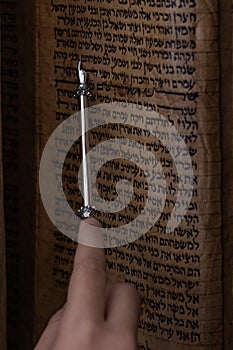 Reading a Sephardi Torah scroll using a small silver pointer