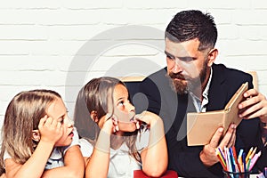 Reading a story. father read book to his daughters.