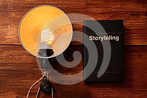 Reading, storytelling and education. Concept for writing, writer and fiction. An old lamp and a book.