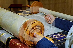 Reading a Torah scroll during a bar mitzvah ceremony .