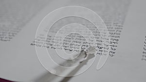 Reading a Torah scroll. Slow motion. Close-up.