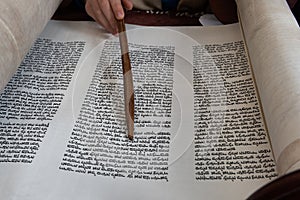 Reading the Torah scroll with a wooden pointer