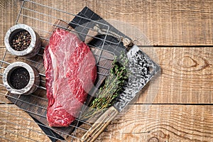 Ready for cooking raw top sirloin beef meat steak on a grill, or rump steak. wooden background. Top view. Copy space