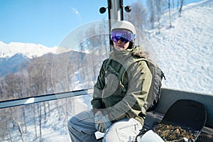 Ready for the Descent: Snowboarder on Lift