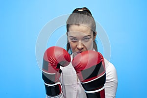 Ready for a fight. Determined business woman wearing boxing gloves.