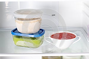 Ready frozen meal in a container in the refrigerator. Frozen food in the freezer