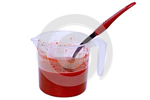 Ready jam with a large spoon in a transparent container