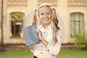 Ready for lessons. Secondary school student. Cute smiling small child hold book. Adorable little girl school student