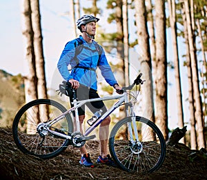 So ready for this. a male cyclist out for a ride on his mountain bike.