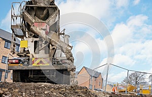 Ready-mix semi-dry concrete delivered on construction site and discharged from mixing truck