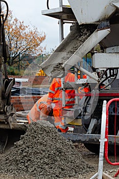 Ready mix semi-dry concrete delivered on construction site and offloaded from concrete wagon on ground