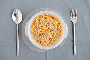 Ready noodle with fork and spoon are prepare