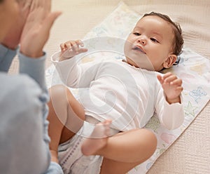 Are we ready for our girls day out. a woman changing her adorable baby girls diaper at home.