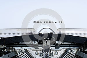 Ready. steady. go. slogan taped words on a vintage typewriter photo