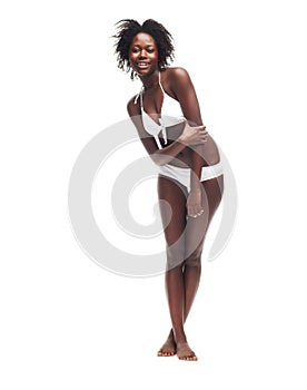 Ready for summer. A beautiful young woman in a white bikini posing against a white background.
