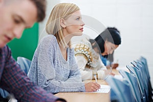 Ready to ace the midterms. university students in a classroom. photo