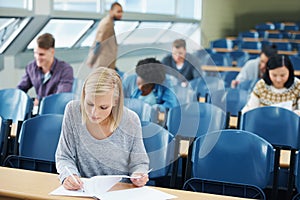 Ready to ace the midterms. university students in a classroom. photo