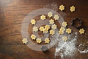 Ready to bake cookies are placed on wooden background