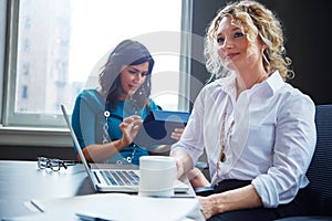 Ready to bring our company into the spotlight. two businesswomen having a meeting together in an office.