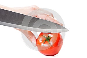 Ready to cut a red tomato with the knife