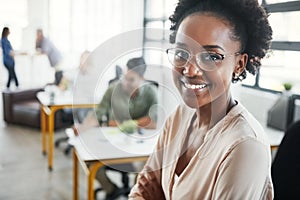 Ready to dive deep into a future of success. a young designer in an office with her colleagues in the background.