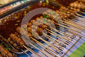 Ready-to-eat meatballs topped with dipping sauce, ready for sale